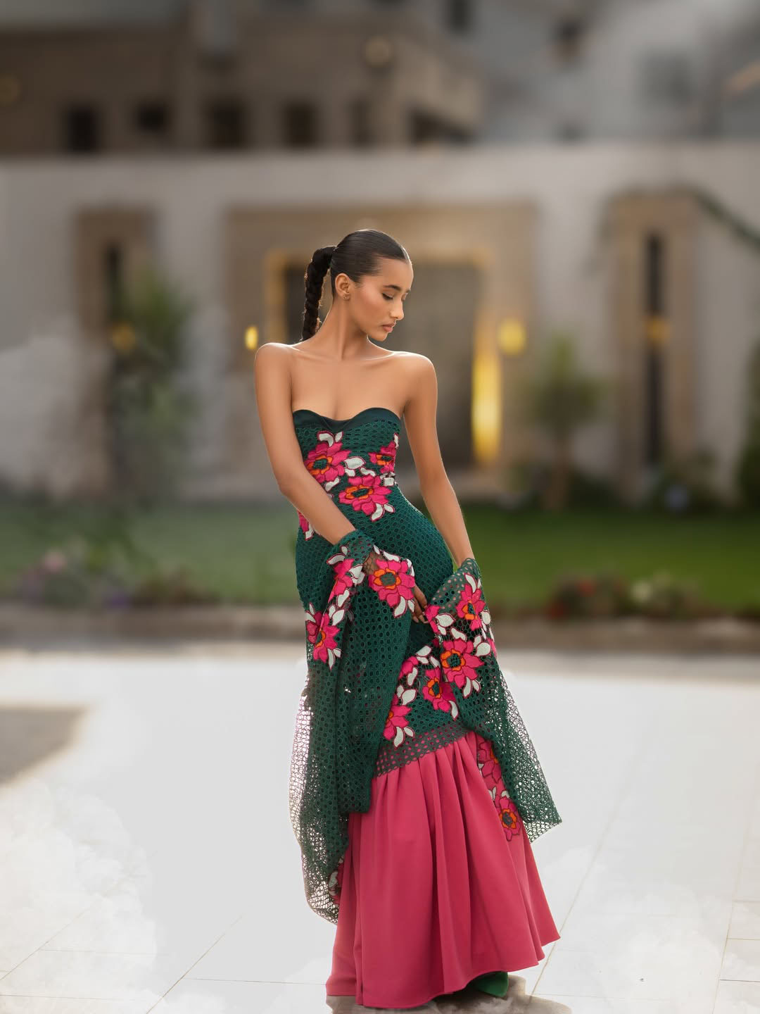 Model wearing Emerald Reverie in a posed studio-style courtyard image